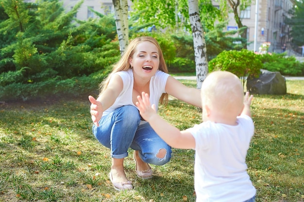 Happy beautiful mother and baby daughter or son