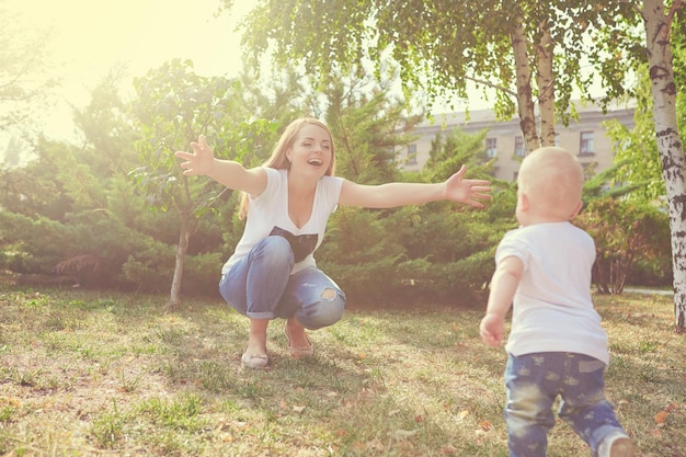 Happy beautiful mother and baby daughter or son