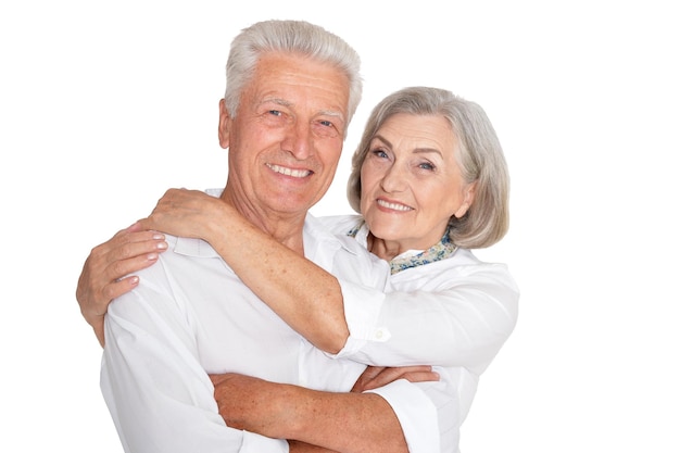 Happy beautiful senior couple huging and posing isolated on white background