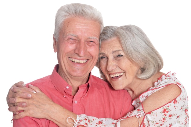 Happy beautiful senior couple huging and posing on white background