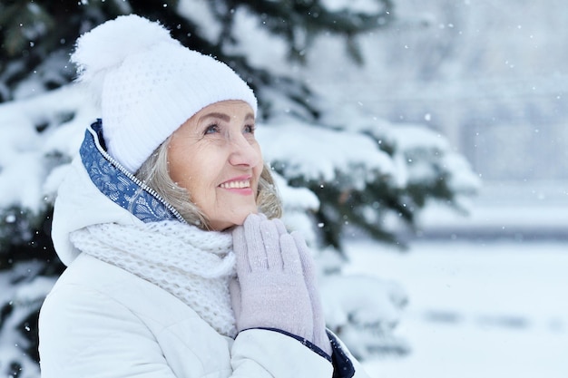 Happy beautiful senior woman in warm hat