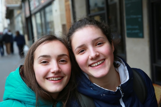 Happy beautiful student girls on the street