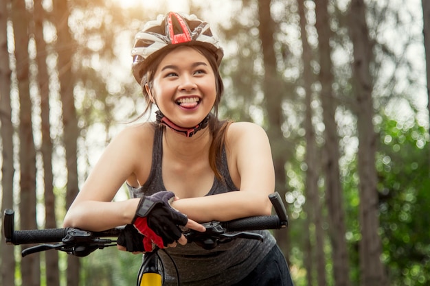 Happy beautiful teen asia on bike exercise during morning time