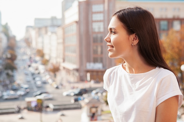 Happy beautiful woman on city streets