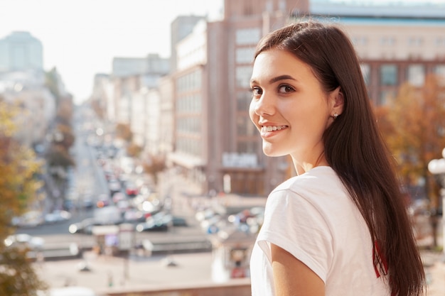 Happy beautiful woman on city streets