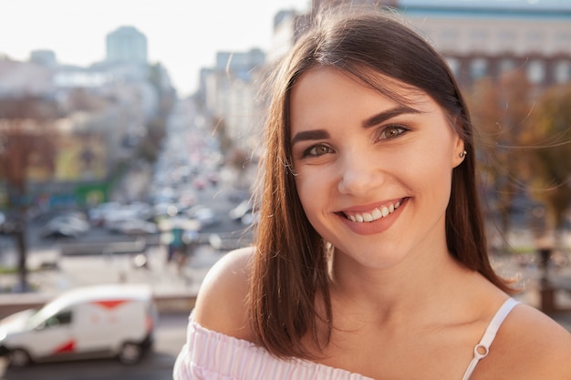 Happy beautiful woman on city streets