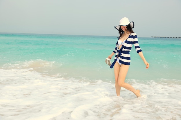 Happy Beautiful Woman Enjoying Summer Vacation on beach