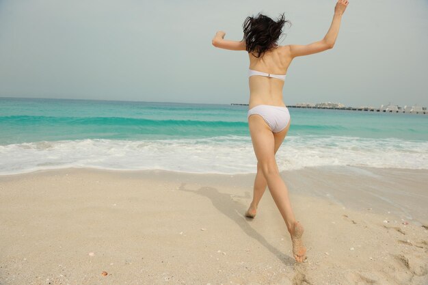 Happy Beautiful Woman Enjoying Summer Vacation on beach