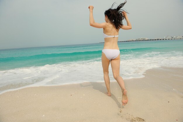 Happy Beautiful Woman Enjoying Summer Vacation on beach