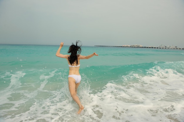 Happy Beautiful Woman Enjoying Summer Vacation on beach