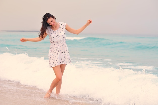 Happy Beautiful Woman Enjoying Summer Vacation on beach