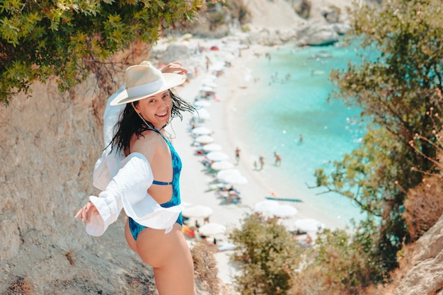 Happy beautiful woman going to the sea beach