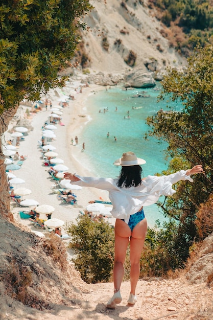 Foto felice bella donna che va alla spiaggia del mare