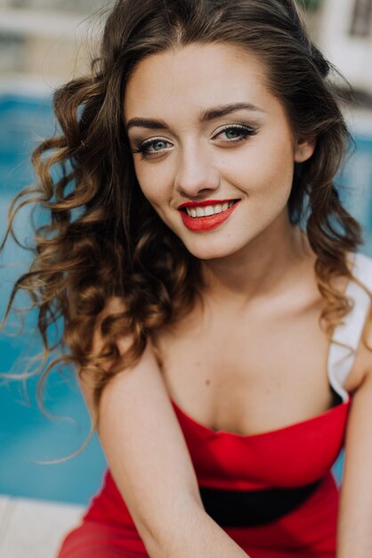 Happy Beautiful Woman in Red Dress on the Beach