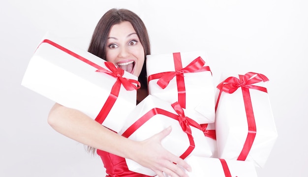 Happy beautiful woman with many gifts isolated on a white background