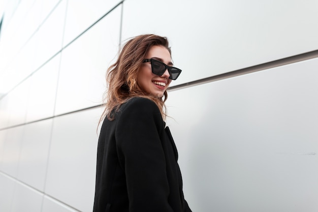 Happy beautiful woman with smile in fashion black clothes