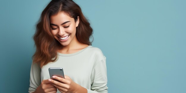 Happy beautiful young woman looking at her cell phone and smiling