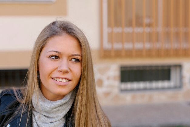 Happy beautiful young woman on street