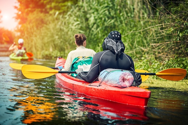 Happy best friends having fun on a kayaks. Kayaking on the river.