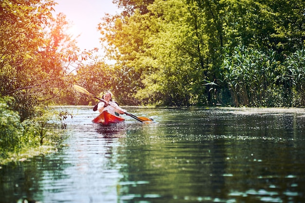 Happy best friends having fun on a kayaks. Kayaking on the river.