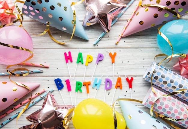 Happy birthday accessories on a wooden background