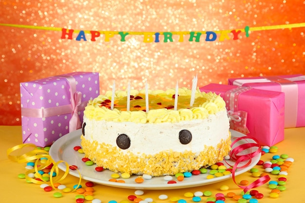 Happy birthday cake and gifts on red background