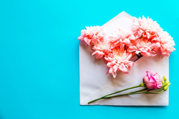 Happy birthday card. opened craft paper envelope filled with spring blossom flowers.