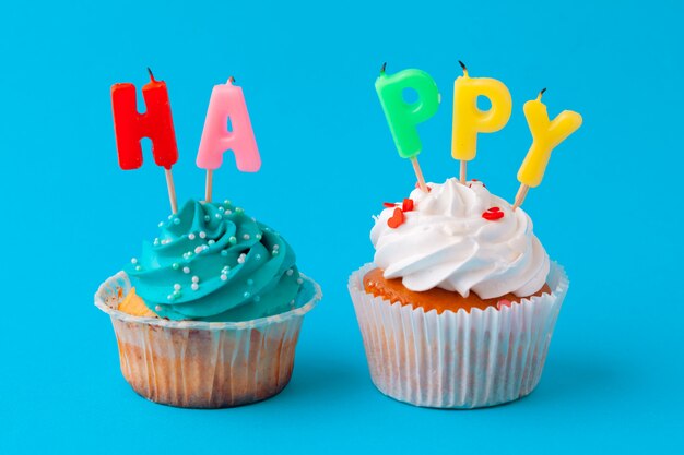 Happy birthday cupcakes on blue background