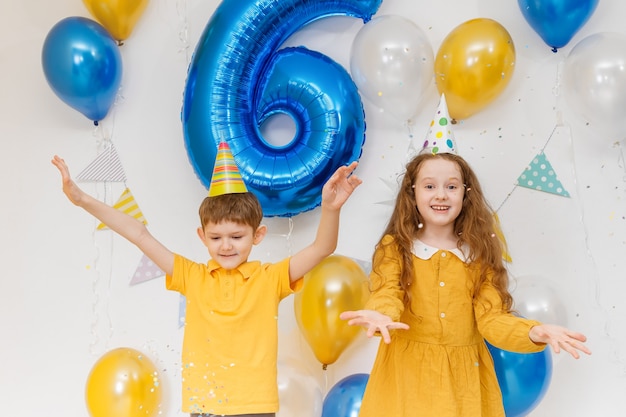 Happy birthday kids with confetti and balloons. Holiday concept.