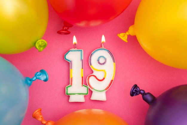 Photo happy birthday number 19 celebration candle with colorful balloons