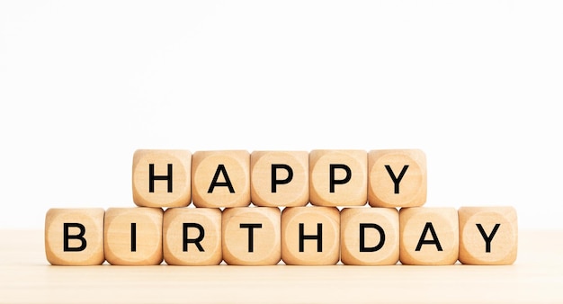 Happy Birthday phrase in wooden blocks on table. Copy space