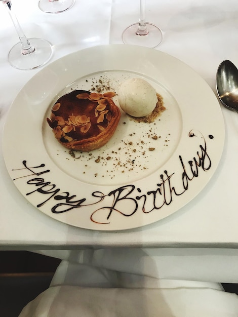 Happy birthday text by dessert on plate