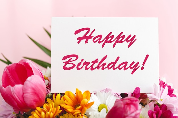 Premium Photo | Happy Birthday Text On Card In Flower Bouquet On Pink  Background. Greeting Card In Tulips, Daisies, Chrysanthemum Beautiful  Spring Bouquet. Flower Delivery, Congratulation Card.