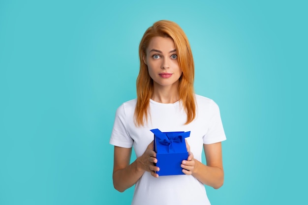 Happy birthday Woman holding gift box with ribbon Studio portrait over blue background