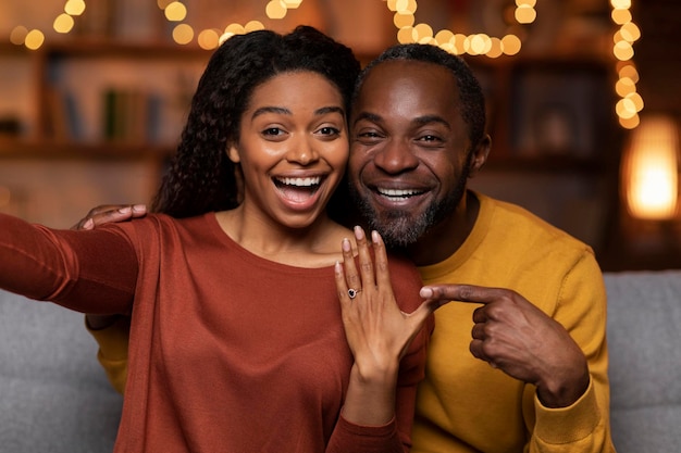 Happy black couple got engaged taking selfie together