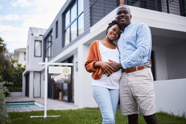 happy black couple portrait and real estate in new home property or mortgage loan together outdoors african man and woman with hug smile or relocation in family house homeowner or building asset