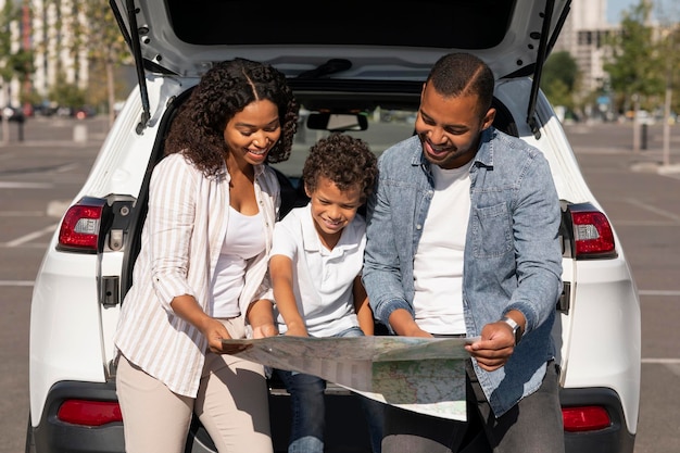 Photo happy black family going car trip together checking map