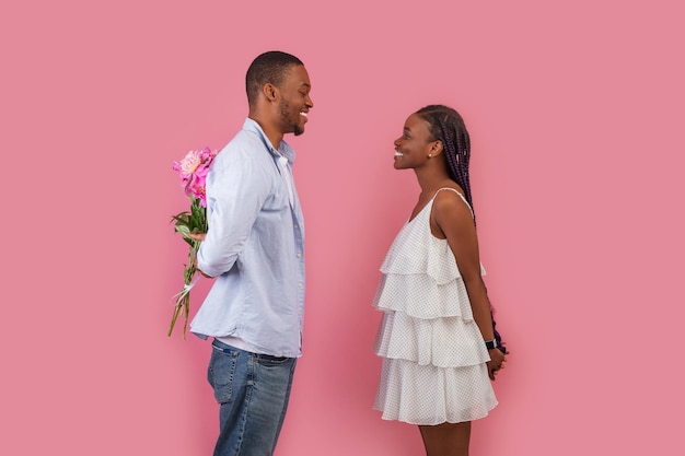 Happy black man making surprise for his woman