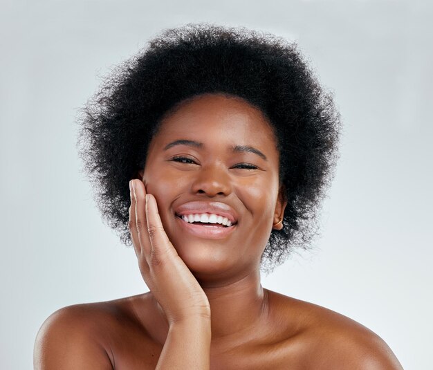 Happy black woman portrait and afro in skincare natural beauty or cosmetics against a white studio background Face of excited African female person smile for perfect skin spa or facial treatment