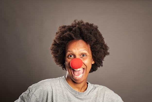 Happy black woman with a clown nose 