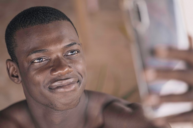 Happy black young man using smartphone