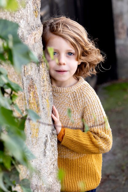 Happy blond child with long hair outside