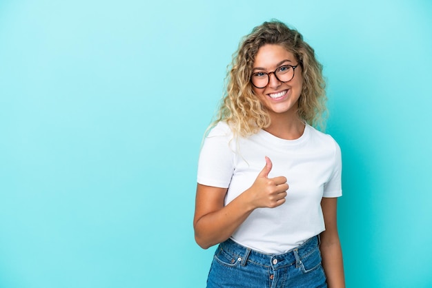 Happy Blonde young woman with salad over isolated pink wall