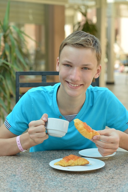 テーブルの上の朝食で幸せな男の子