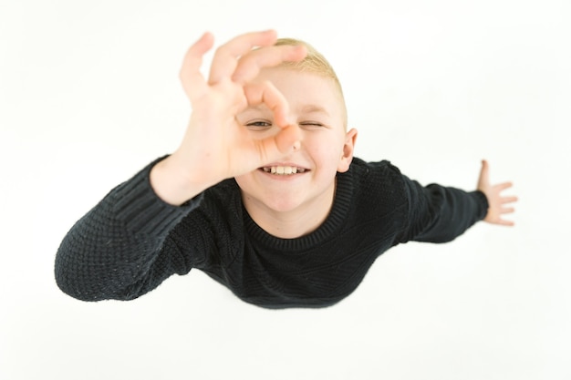 The happy boy gesture to the camera. View from above