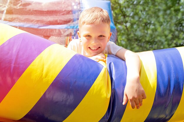 Happy boy on the inflatable trampolineFamily fun concept