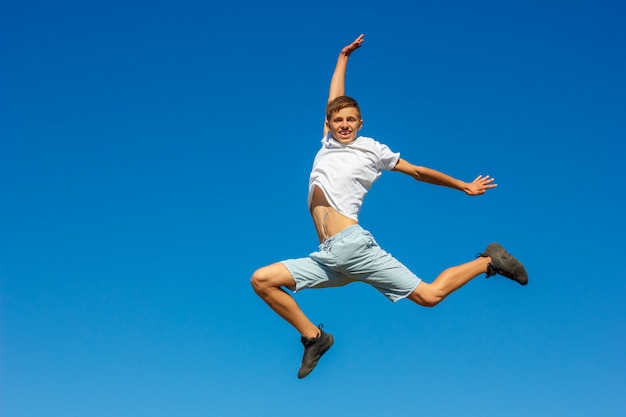 happy boy jumping in the blue sky