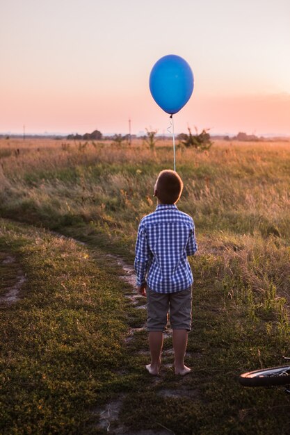 Happy Boy makes his wishes and dreams Outdoors with  Balloon Beautiful summer card  freedom