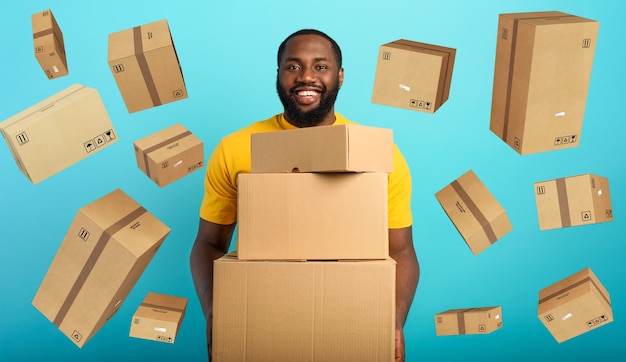 Happy boy receives a lot of packages from online shop order.