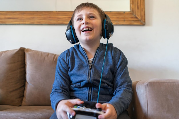 Happy boy sitting on sofa at home